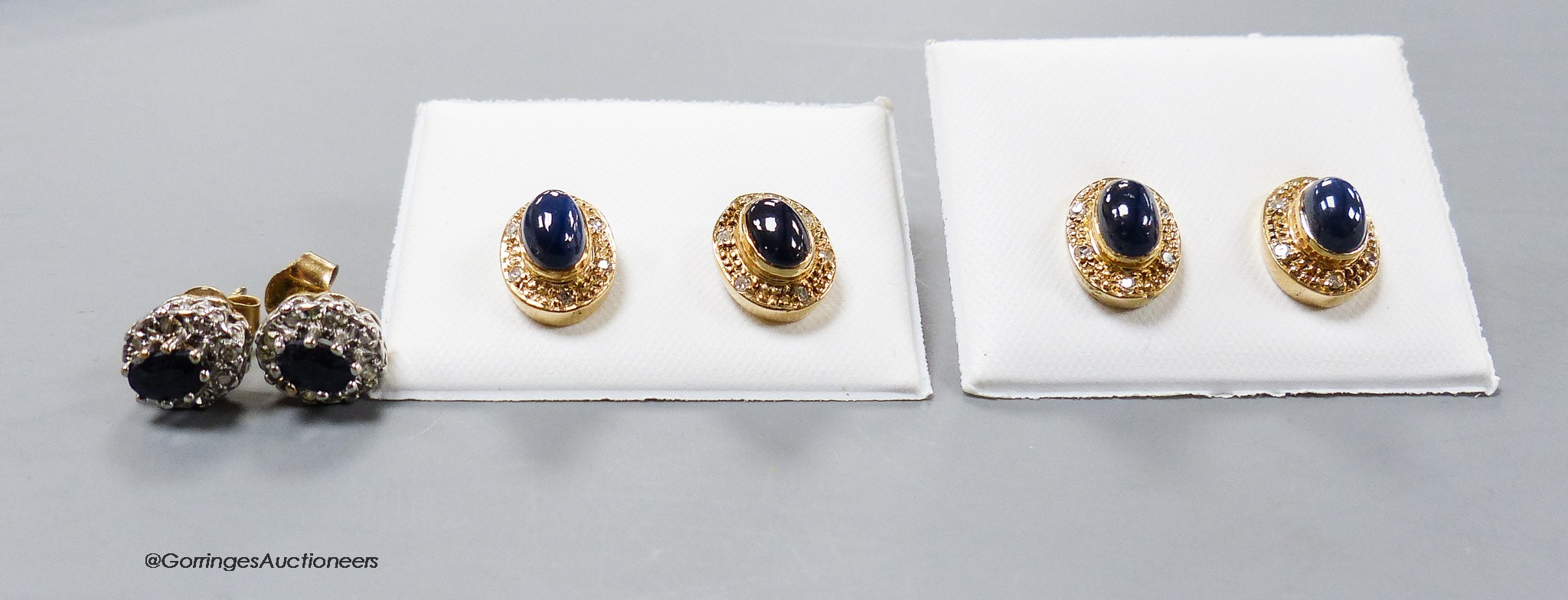 Three modern pairs of 9ct and gem set ear studs, including cabochon blue stone and diamond chip.
